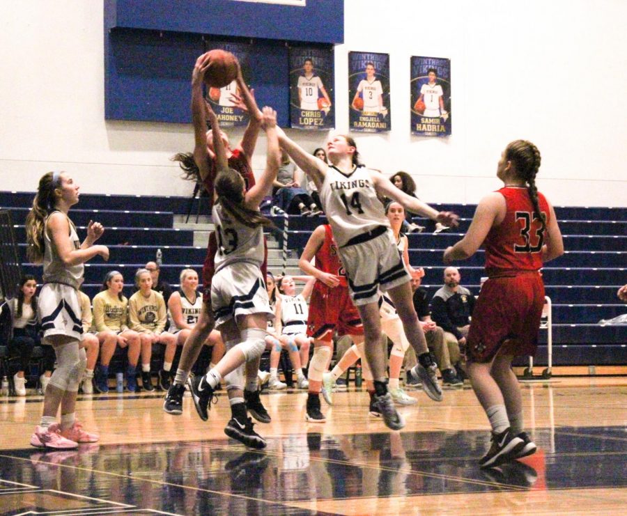Junior Caroline Earl (right) and Sophomore Julia Marcoccio (middle) reach for and stop the ball as Salems team attempts to score, Freshman Maddie Stillest (left) waits for the rebound.
