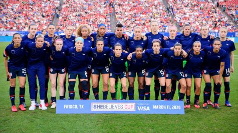 Photo courtesy of Sports Illustrated. To protest for equal pay, the USWNT wear their training uniform inside out so the US Soccer Federation crest is not visible.