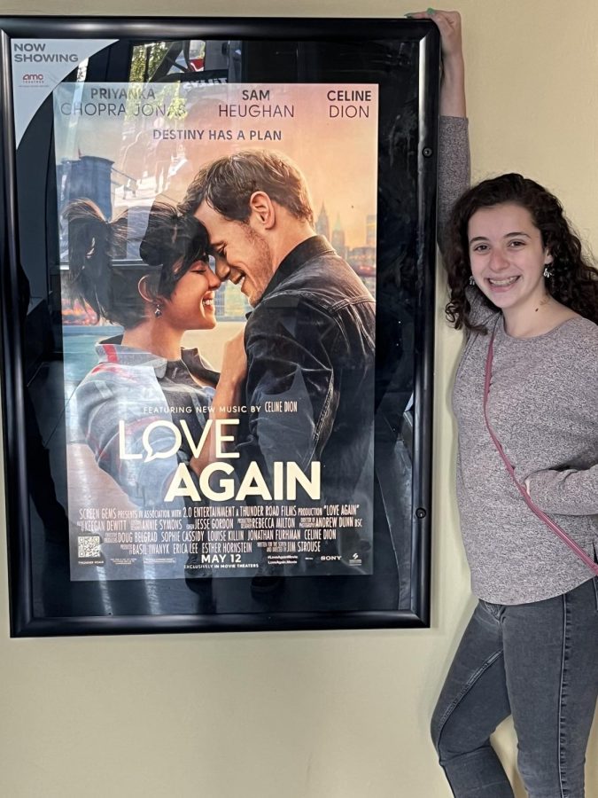 Me standing next to the poster for Love Again.